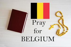 Pray for Belgium. Rosary and Holy Bible background. photo