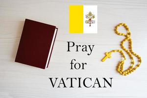 Pray for Vatican. Rosary and Holy Bible background. photo