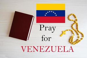 Pray for Venezuela. Rosary and Holy Bible background. photo