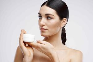 Brunette Bare Shoulders Cream Jar Dermatology photo