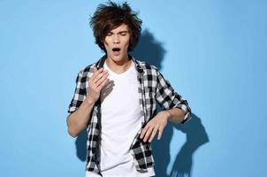 handsome young man with tousled hair plaid shirt posing photo