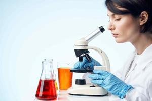 female doctor medical gown chemical solution microscope examination photo