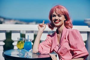 smiling woman in pink with pink hair vintage alcohol cocktails restaurant photo