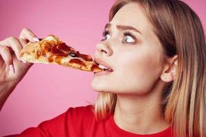 woman in red t-shirt snack fast food pink background photo