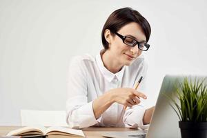 woman in costume in front of laptop with glasses self-confidence light background photo