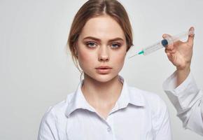 scared woman and syringe with needle near face photo