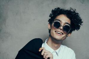 man wearing sunglasses curly hair shirt jacket photo