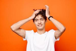 cute guy with curly hair in a white t-shirt close-up photo