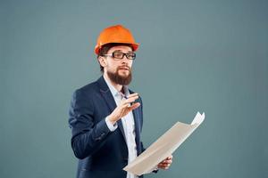 Male engineer with blueprints in the hands of an orange hard hat Industry professional photo