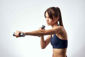 sports brunette with dumbbells in hands workout fitness exercise photo