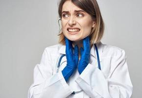 Woman doctor in a medical gown blue gloves stethoscope work a nurse photo