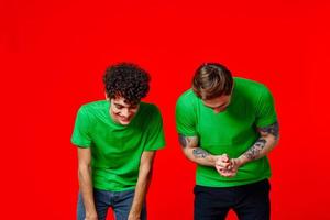 Two cheerful friends in green t-shirts joy of communication photo