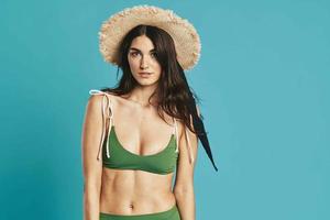 pretty woman in green swimwear beach hat posing fashion photo