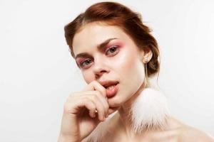 pretty woman with bright makeup fluffy earrings close-up fashion photo