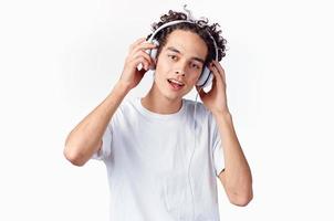 Cheerful man with curly hair in headphones listens to music emotions photo