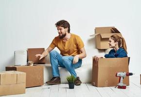 alegre joven Pareja cajas con cosas interior habitación herramientas Moviente foto