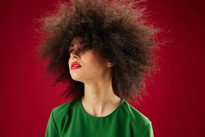 Young woman with curly hair grimace posing emotion studio model unaltered photo