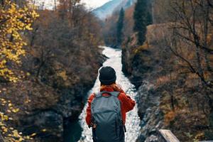 woman hiker backpack mountains river fresh air photo