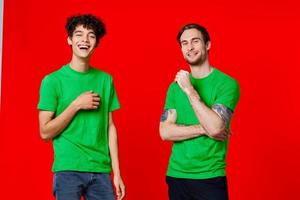 Cheerful friends Green t-shirt communication emotions red background photo