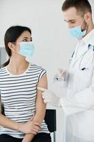 male doctor giving an injection to the patient's hand health covid photo