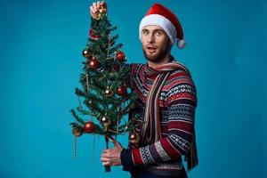 Cheerful man in a santa hat holding a banner holiday studio posing photo