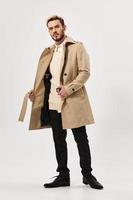 handsome man in coat fashion modern style studio isolated background photo