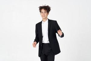 stylish guy with curly hair and in a jacket shirt pants model photo