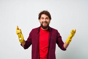 Man with detergent professional cleaning homework light background photo
