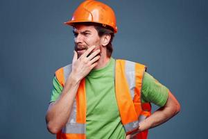 Worker man orange hard hat safety Professional blue background photo