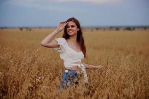 cheerful woman outdoors in the field freedom fun landscape photo