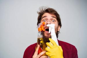 cheerful man with detergent in hands rendering of services cropped view close-up photo