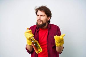 Man in rubber gloves detergent emotions red shirt housework photo