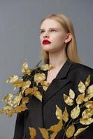 woman golden leaves black blazer red lips studio model unaltered photo