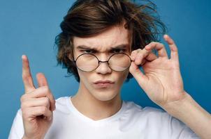 cute guy with tousled hair wearing glasses fashion close up photo