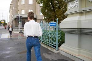 pretty woman with glasses walking around the city with a book Lifestyle photo