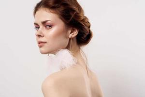 woman with bare shoulders fluffy earrings fashion close up photo