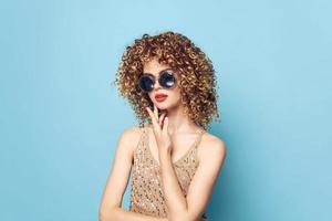 Cheerful woman curly hair Charm fashionable clothes attractive look blue background photo