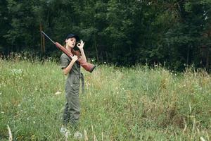 Military woman With arms on shoulder travel is a fresh air lifestyle green overalls photo