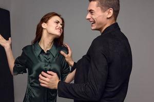 cheerful man and aggressive woman slap in the face conflict gray backgroun photo
