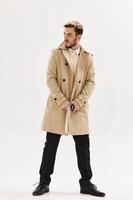 man with trendy hairstyle coat modern style self-confidence model photo