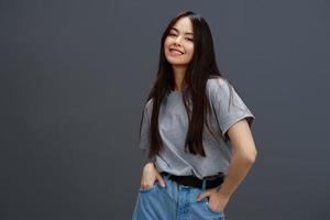 Brunette with long hair in a gray T-shirt gesturing with hands Lifestyle photo