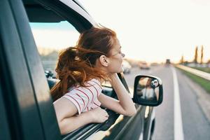 Cheerful woman car trip travel fresh air photo