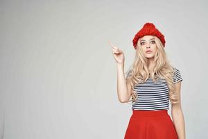 beautiful woman in a striped T-shirt Red Hat posing Studio photo