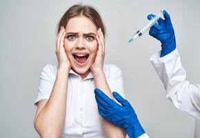 doctor blue gloves and woman syringe anesthesia botox injection photo