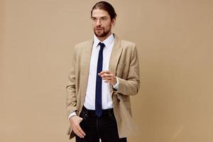 handsome man emotional man in suit gesture with hands beige background photo