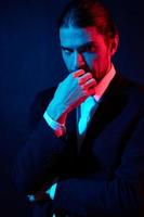 portrait of a man gestures with his hands attractive look neon light photo