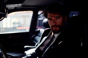 emotional man in a suit in a car a trip to work self confidence photo