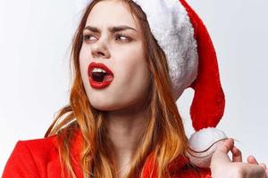 woman wearing santa hat holiday christmas fashion posing photo