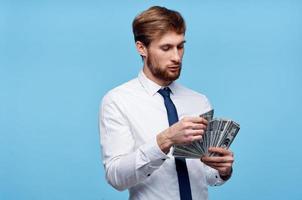 Virgo man in tie with money in hands wealth success self-confidence photo