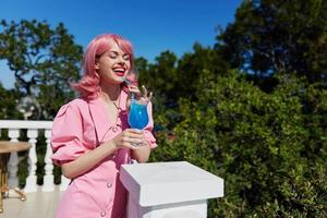 attractive woman with pink hair summer cocktail refreshing drink Summer day photo